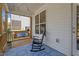 Cozy screened-in porch with a swing, rocking chair, and outdoor seating area at 12658 W Hanes Ave, Middlesex, NC 27557