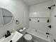 Bathroom featuring black hardware, white subway tile, and a tub with a shower at 1336 Hill Street St, Rocky Mount, NC 27801