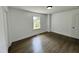 Minimalist bedroom design featuring hardwood floors, a window, and a white door at 1336 Hill Street St, Rocky Mount, NC 27801