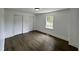 Bright bedroom with hardwood floors, two closets, white walls, and a window overlooking the yard at 1336 Hill Street St, Rocky Mount, NC 27801