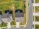 Aerial view of a fenced-in backyard featuring green grass, along with the home and surrounding street at 14 Shady Oaks Rd, Angier, NC 27501
