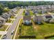 Aerial view of a white two-story home with a large green backyard in a suburban neighborhood at 14 Shady Oaks Rd, Angier, NC 27501