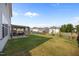 Home's backyard featuring a patio set under a pergola and a large grassy lawn at 14 Shady Oaks Rd, Angier, NC 27501