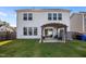 Home's backyard featuring a patio set under a pergola, surrounded by a lawn at 14 Shady Oaks Rd, Angier, NC 27501