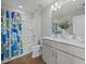 Bathroom with double sink vanity and framed mirror; the shower has a blue and green curtain at 14 Shady Oaks Rd, Angier, NC 27501
