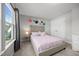 Light-filled bedroom with floral decorations, carpet, and large window overlooking the yard at 14 Shady Oaks Rd, Angier, NC 27501