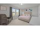 Bright bedroom featuring neutral walls, flower wall decor, carpet, and large window at 14 Shady Oaks Rd, Angier, NC 27501
