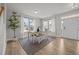 Bright dining area featuring hardwood floors, a stylish table setting, and large windows with sheer curtains at 14 Shady Oaks Rd, Angier, NC 27501