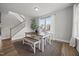 Inviting dining space with wood floors, a modern table and bench set, and natural light from nearby windows at 14 Shady Oaks Rd, Angier, NC 27501