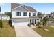 Attractive two-story home boasting well-maintained landscaping, a two-car garage, and cozy front porch at 14 Shady Oaks Rd, Angier, NC 27501