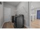 Well-lit laundry room features modern washer/dryer set, wire shelving, and neutral paint at 14 Shady Oaks Rd, Angier, NC 27501