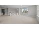 Neutral loft space with carpet, staircase, and bright windows overlooking the neighborhood at 14 Shady Oaks Rd, Angier, NC 27501