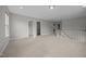 Bright loft space with neutral carpet, stairway, and multiple doorways at 14 Shady Oaks Rd, Angier, NC 27501