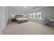 Spacious main bedroom suite with carpet, tray ceiling, and large windows with natural light at 14 Shady Oaks Rd, Angier, NC 27501