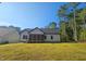 Exterior back view of the home from the backyard showing a screened porch at 1414 Sagamore Dr, Louisburg, NC 27549