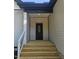 Close up of front porch featuring a decorative front door, steps, and railing at 1414 Sagamore Dr, Louisburg, NC 27549