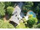 Aerial view of a home with a pool, patio and beautifully landscaped yard surrounded by mature trees at 14236 Wyndfield Cir, Raleigh, NC 27615