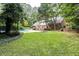 Expansive backyard featuring a gunite pool, lush greenery and an abundance of mature trees at 14236 Wyndfield Cir, Raleigh, NC 27615