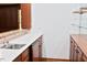 Bar area featuring a mini-fridge, marble countertop, and glass shelving at 14236 Wyndfield Cir, Raleigh, NC 27615