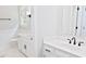 Well-lit bathroom with double vanity sinks, quartz counters, and neutral color scheme at 14236 Wyndfield Cir, Raleigh, NC 27615
