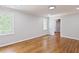 Bright bedroom with wood floors, neutral paint, and white trim with natural light from windows at 14236 Wyndfield Cir, Raleigh, NC 27615