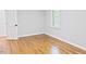 Bedroom with hardwood floors, neutral walls, white door, window and trim with natural light at 14236 Wyndfield Cir, Raleigh, NC 27615