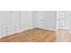 Bedroom featuring beautiful hardwood floors, large built-in cabinets, white doors and neutral color scheme at 14236 Wyndfield Cir, Raleigh, NC 27615