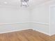 Empty dining room boasting hardwood floors, fresh paint, and white trim at 14236 Wyndfield Cir, Raleigh, NC 27615