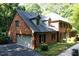 Classic brick home with an attached garage, dormer windows, and mature landscaping at 14236 Wyndfield Cir, Raleigh, NC 27615