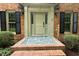 Charming front entrance with a brick pathway and decorative landscaping at 14236 Wyndfield Cir, Raleigh, NC 27615