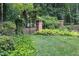 Serene front yard with a wrought iron fence and lush landscaping at 14236 Wyndfield Cir, Raleigh, NC 27615
