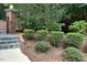 Charming front yard with lush landscaping and a brick and iron gate at 14236 Wyndfield Cir, Raleigh, NC 27615