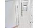 Tiled hallway leads to laundry room with washer and dryer hookups at 14236 Wyndfield Cir, Raleigh, NC 27615
