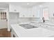 Bright and updated kitchen with white cabinets, stainless steel appliances, and island cooktop at 14236 Wyndfield Cir, Raleigh, NC 27615