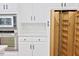 Modern kitchen featuring white cabinets, built-in stainless appliances, and pull-out pantry at 14236 Wyndfield Cir, Raleigh, NC 27615