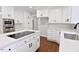 Updated kitchen with white cabinetry, stainless steel appliances, and a functional layout at 14236 Wyndfield Cir, Raleigh, NC 27615