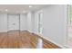 Spacious living room with hardwood floors, white trim, fresh paint and natural light at 14236 Wyndfield Cir, Raleigh, NC 27615