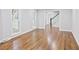 Large living room with hardwood floors, fresh paint, white trim and an abundance of windows at 14236 Wyndfield Cir, Raleigh, NC 27615