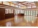 Open living room with a bar area, coffered ceilings, and a wall of windows overlooking the outdoors at 14236 Wyndfield Cir, Raleigh, NC 27615