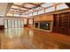 Open-concept living room with coffered ceilings, brick fireplace, and hardwood floors at 14236 Wyndfield Cir, Raleigh, NC 27615