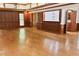 Spacious living room featuring hardwood floors, wood paneling, and a built-in bar area at 14236 Wyndfield Cir, Raleigh, NC 27615