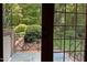 Charming stone patio with outdoor views of the lush garden and green landscaping at 14236 Wyndfield Cir, Raleigh, NC 27615