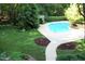 Aerial view of a private swimming pool surrounded by mature trees and manicured lawns at 14236 Wyndfield Cir, Raleigh, NC 27615