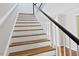 Staircase with hardwood treads and white risers at 14236 Wyndfield Cir, Raleigh, NC 27615