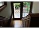 Wooden stairs leading to the lower level exit to brick patio overlooking gardens at 14236 Wyndfield Cir, Raleigh, NC 27615