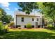 Back of house features steps to back door, A/C unit and manicured landscaping at 1543 Wickham St, Burlington, NC 27215