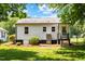Back of house features steps to back door, A/C unit and manicured landscaping at 1543 Wickham St, Burlington, NC 27215