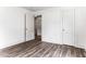 This bedroom features wood-look flooring and two white doors, providing both style and functionality at 1543 Wickham St, Burlington, NC 27215