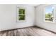 This bedroom features wood-look floors and an abundance of natural light from its two windows at 1543 Wickham St, Burlington, NC 27215