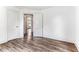 Bedroom with wood-look flooring, two white doors, and a view into another room at 1543 Wickham St, Burlington, NC 27215